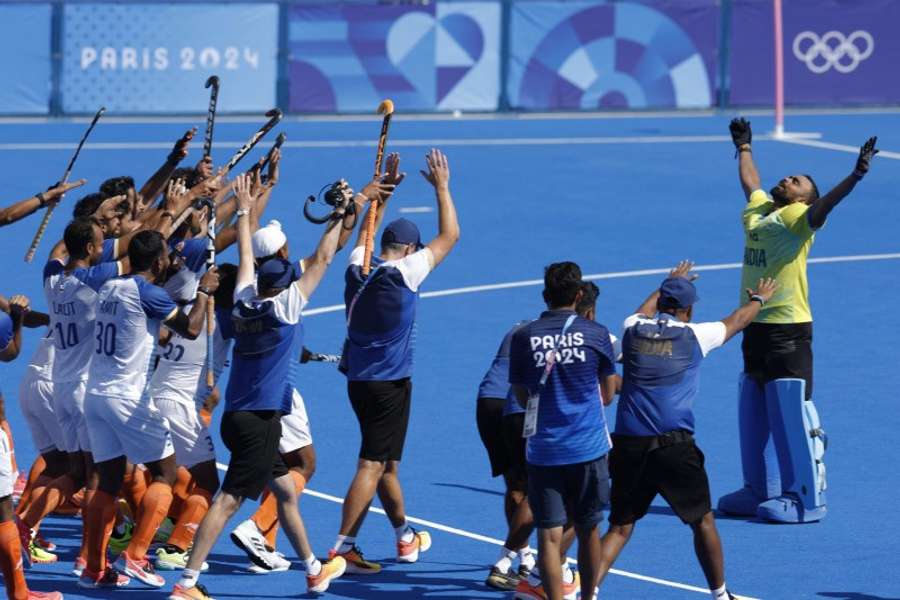 India's goalkeeper Sreejesh celebrates with teammates after winning the match