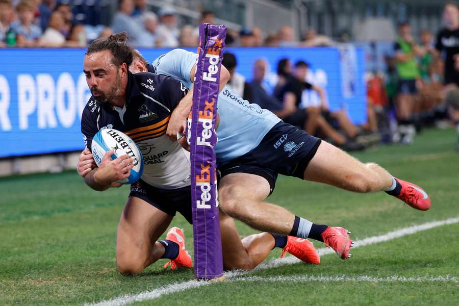 Waratahs winger Max Jorgensen denies Brumbies' Andy Muirhead a certain try.