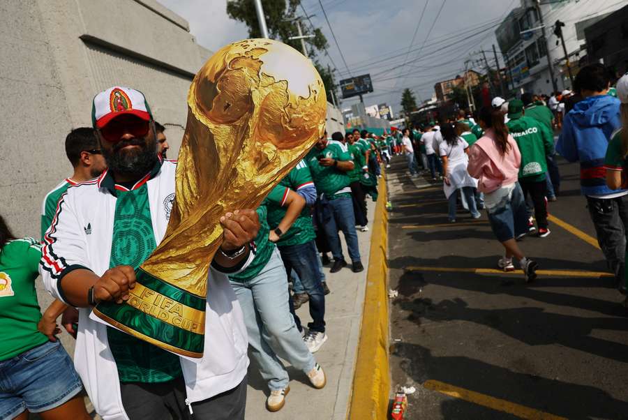A Mexico fan displays a giant replica of the World Cup trophy outside the stadium before the match A Mexico fan displays a giant replica of the World Cup trophy outside the stadium before the match