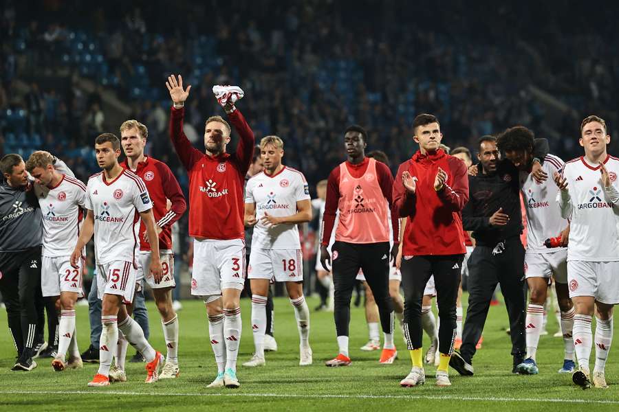 Dusseldorf players applaud their fans after the match