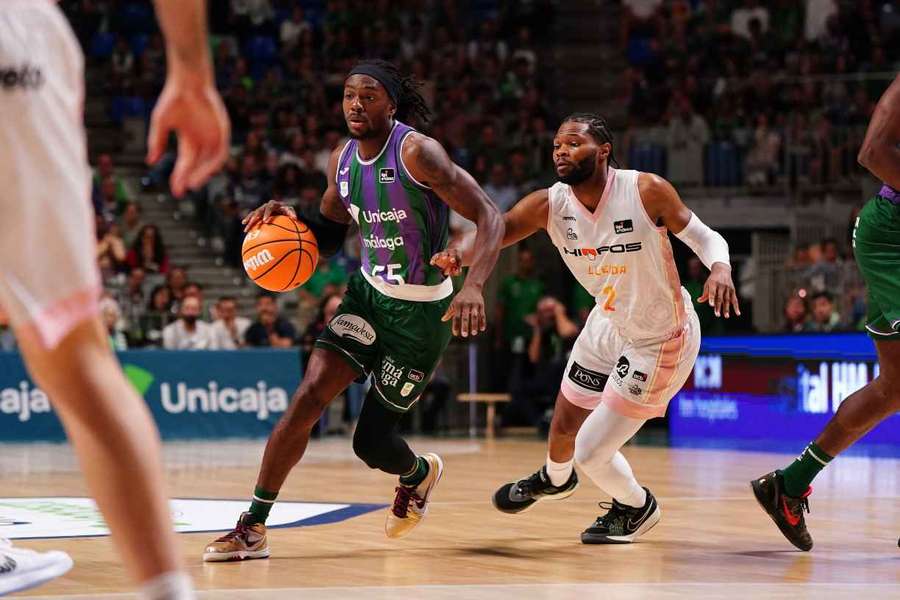 Kendrick Perry intenta zafarse de Walden en el Unicaja-Hiopos Lleida