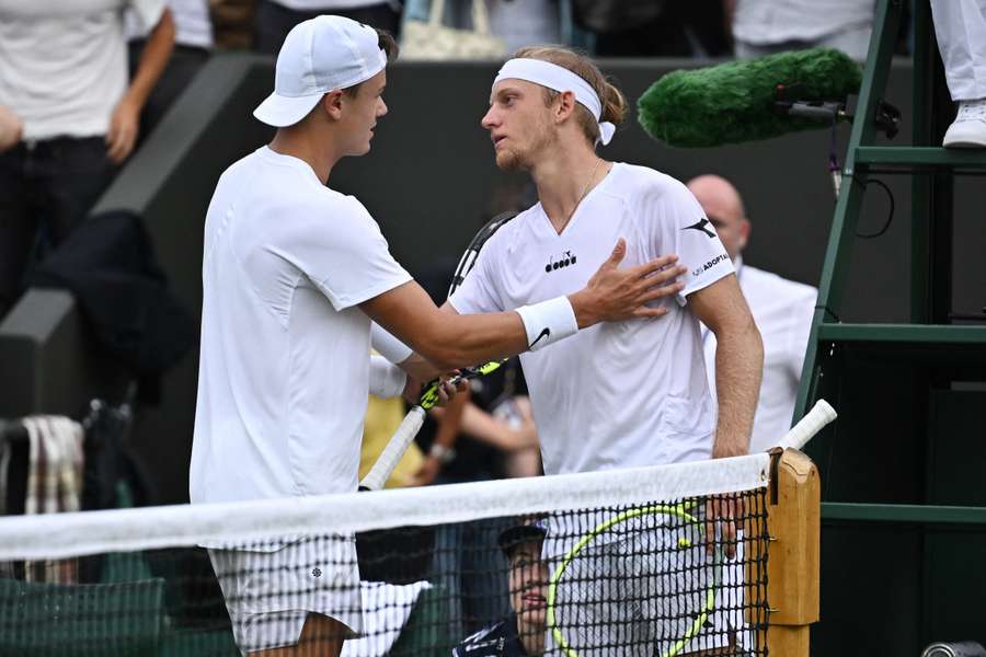 Holger Rune and Alejandro Davidovich Fokina meet at the net after their four-hour epic
