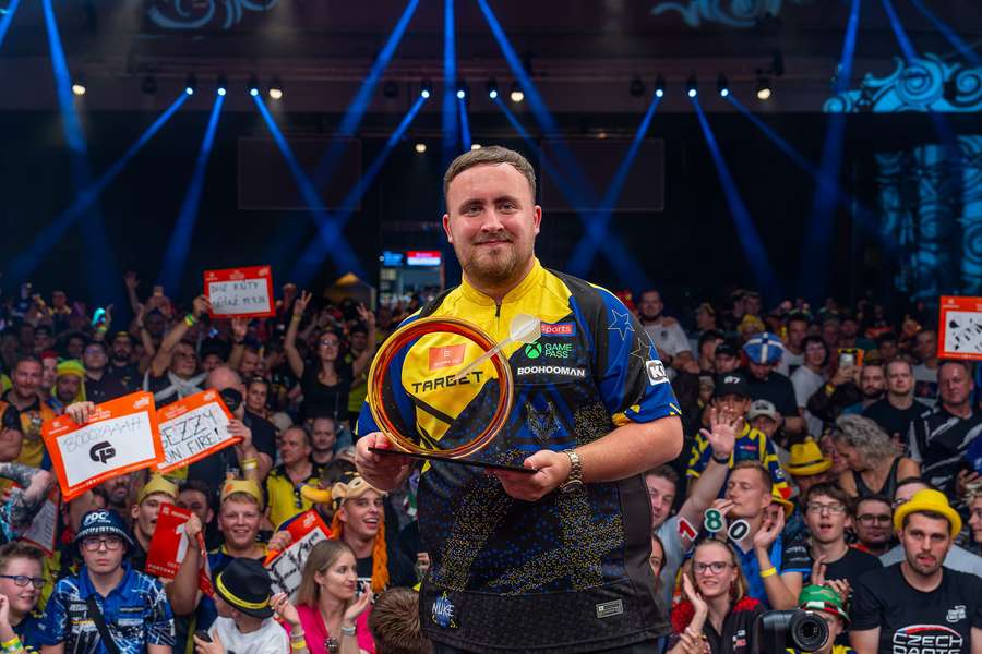 Luke Littler with the trophy Luke Littler with the trophy