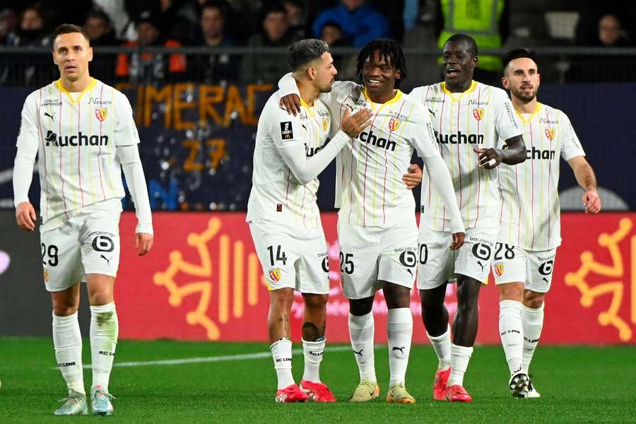 Nosakhare Agbonifo, centre, is congratulated by his teammates after scoring the second goal for Lens