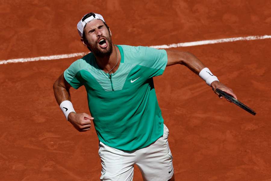 Karen Khachanov pumps the air with celebration during his match with Lorenzo Sonego