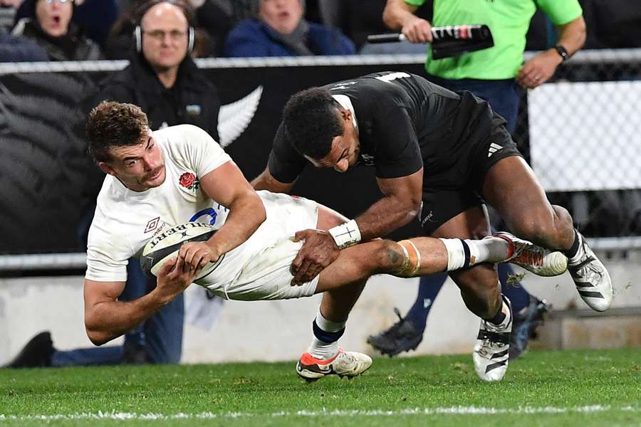 Furbank (L) is tackled in a game against the All Blacks