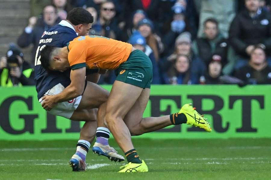 Joseph Suaalii injured his wrist making this tackle on Scotland's Sione Tuipulotu last year.