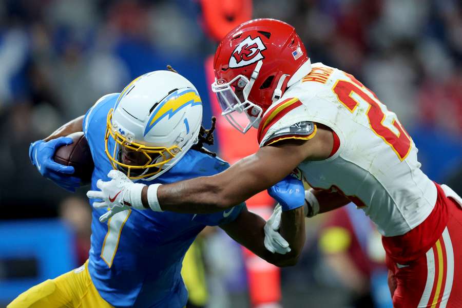 Quentin Johnston of the Los Angeles Chargers runs with the ball while being tackled by Jaden Hicks of the Kansas City Chiefs Quentin Johnston of the Los Angeles Chargers runs with the ball while being tackled by Jaden Hicks of the Kansas City Chiefs