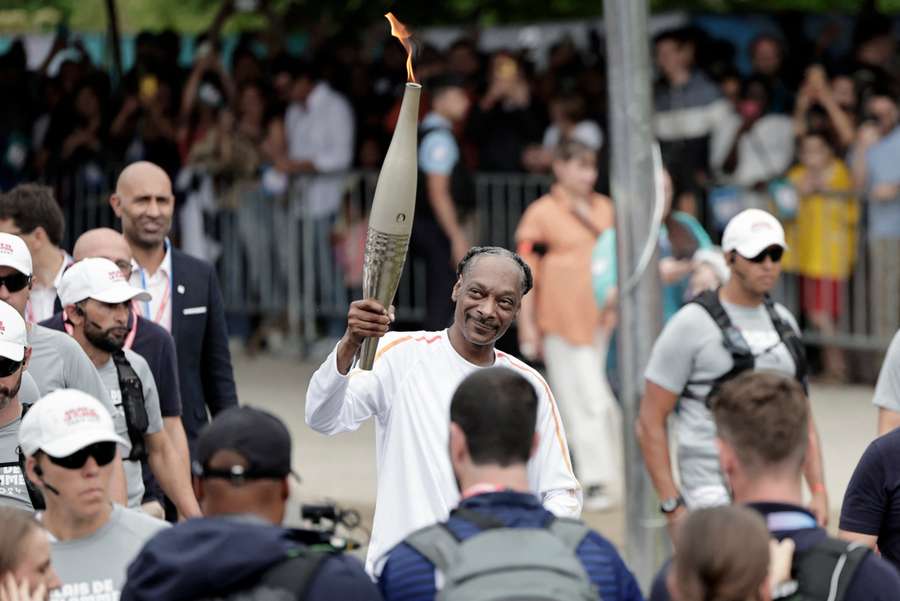 Snoop Dogg carries the Olympic torch ahead of the opening ceremony