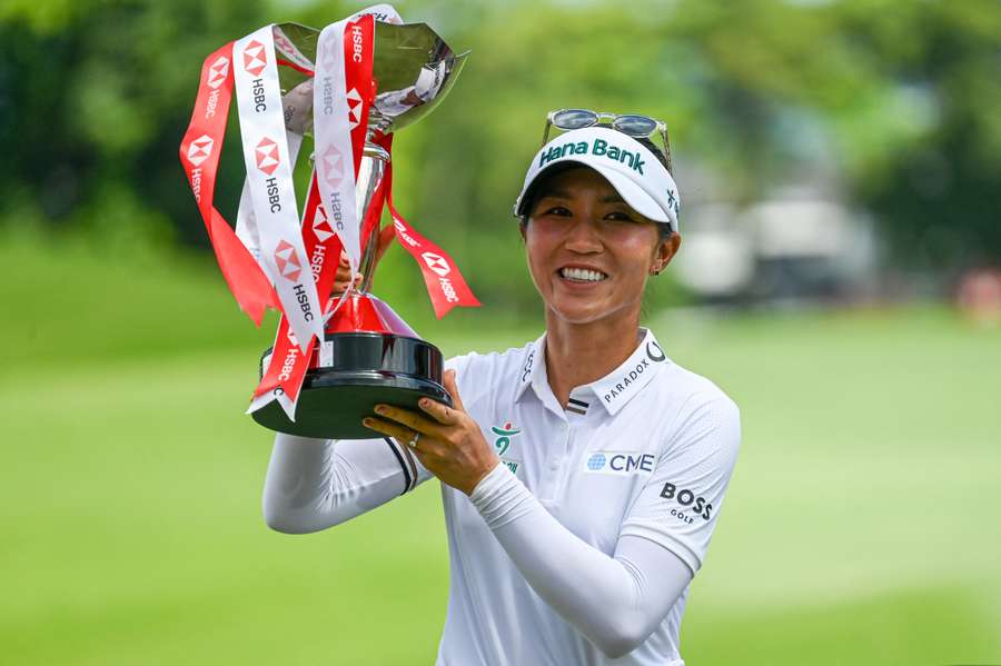 Lydia Ko poses with the trophy after winning the HSBC Women's Championship