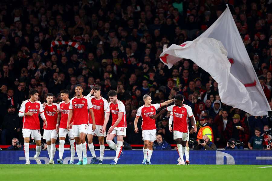 Leandro Trossard of Arsenal (C) celebrates after scoring the team's first goal with teammate Bukayo Saka