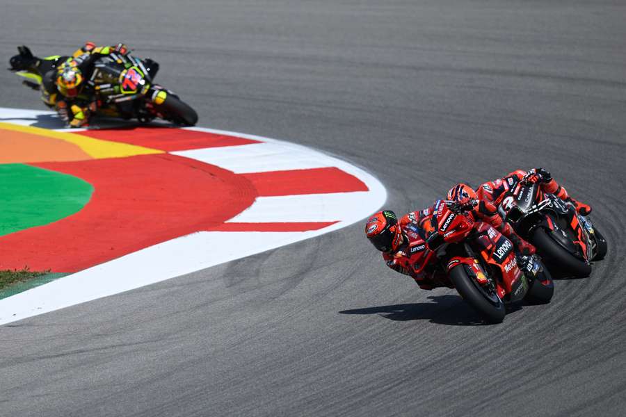 Ducati Italian rider Francesco Bagnaia rides ahead of Aprilia Spanish rider Maverick Vinales and Ducati Italian rider Marco Bezzecchi 