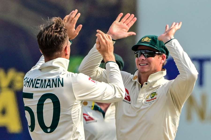 Matthew Kuhnemann celebrates a wicket with Steve Smith