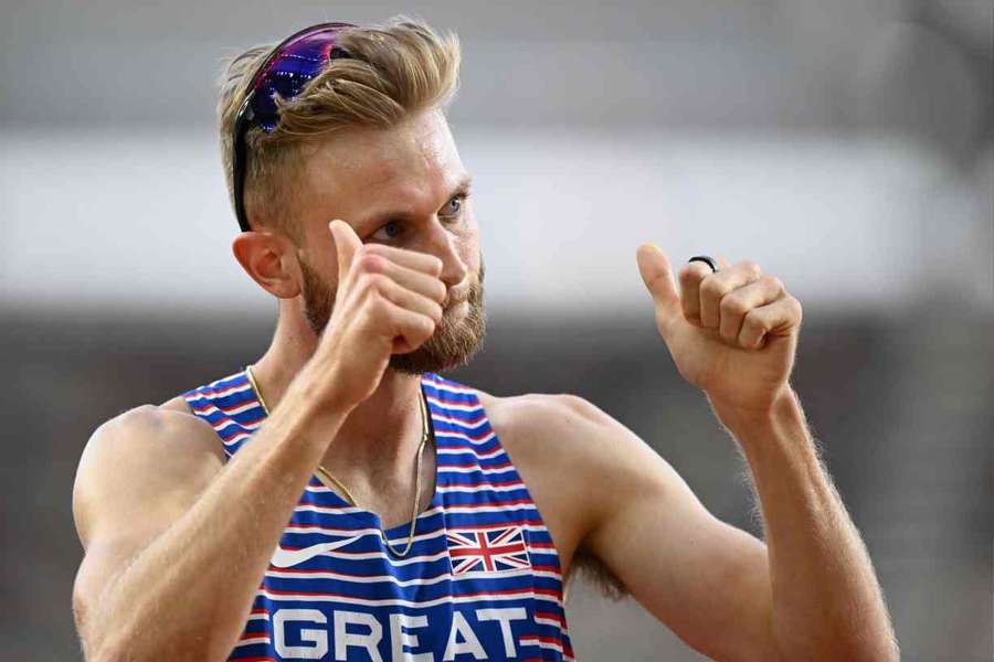 Josh Kerr celebrates after reaching the semi-finals of the men's 1,500m