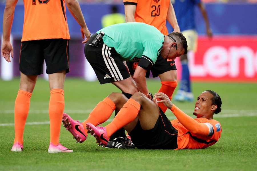 Referee Michael Oliver checks on Netherlands' Virgil van Dijk after he sustained an injury against Sweden Referee Michael Oliver checks on Netherlands' Virgil van Dijk after he sustained an injury against Sweden