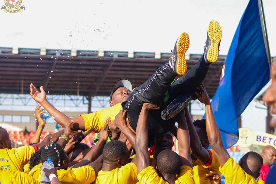 Police players celebrate with their coach