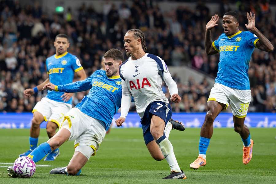Wolves' Santiago Bueno tackles Tottenham's Xavi Simons