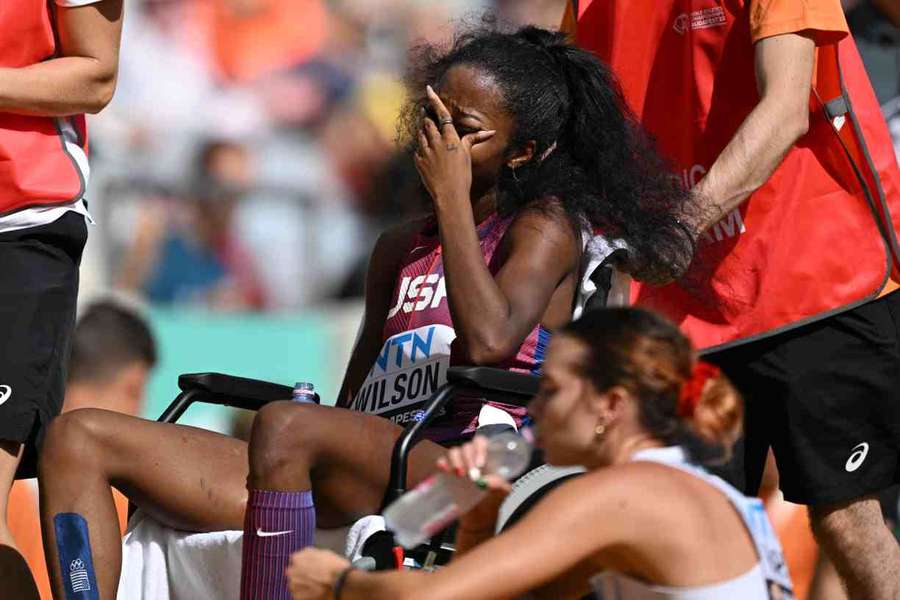 Britton Wilson leaves the track in tears after being transported in a wheelchair following the women's 400m heats