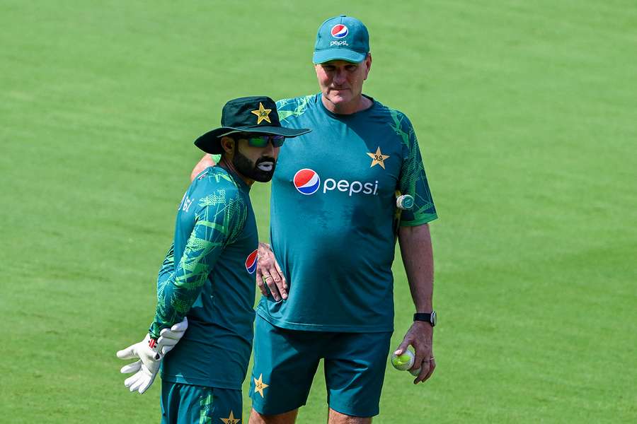 Pakistan's Mohammad Rizwan (L) talks with Grant Bradburn