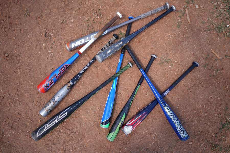 Baseball bats lay on a field during a training session in Havana, Cuba