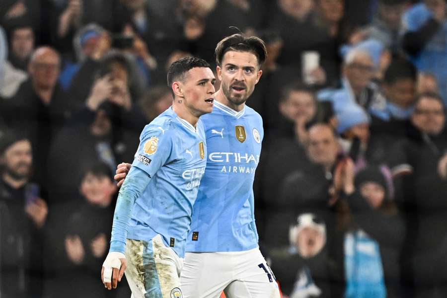 Phil Foden (L) celebrates with Manchester City's English midfielder #10 Jack Grealish after scoring his team's fourth