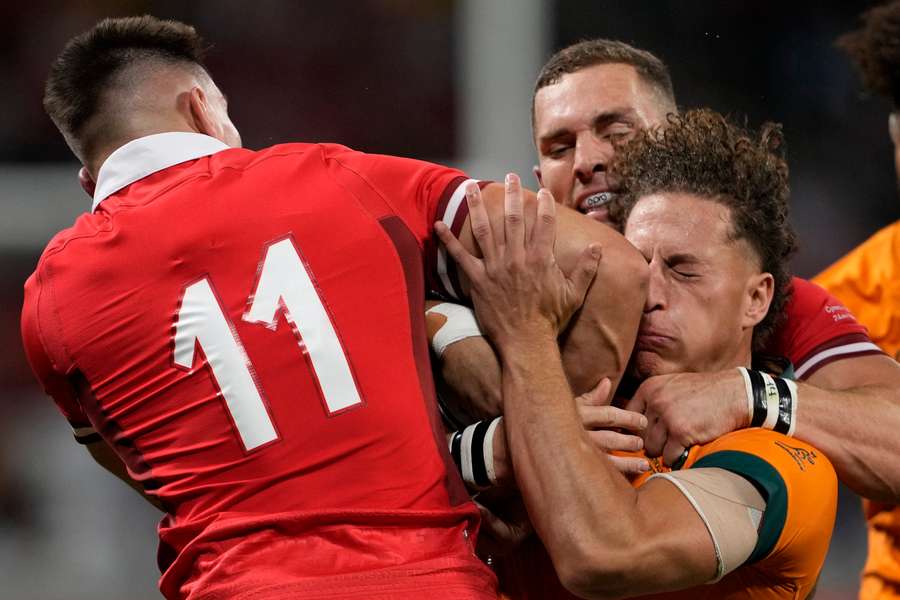 Wales' left wing Josh Adams (L) collides with Australia's wing Mark Nawaqanitawase