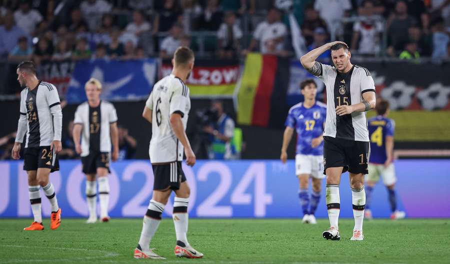 Germany's defender #15 Niklas Suele (R) reacts during the friendly football match between Germany and Japan