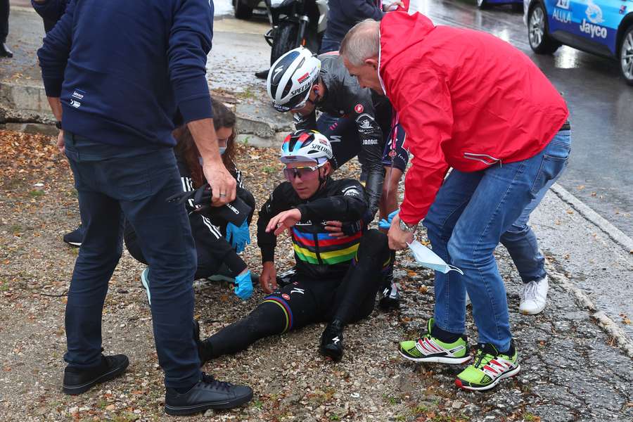 Remco Evenepoel is assisted by members of his team after crashing during the fifth stage of the Giro d'Italia