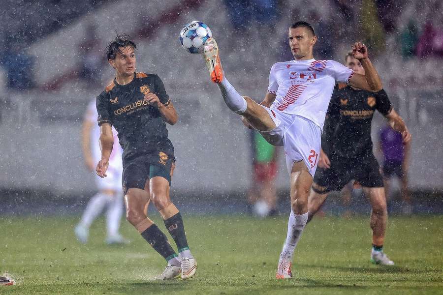 FC Utrecht's Victor Jensen battles with Zrinjski Mostar's Ivan Savic in a rainy Mostar