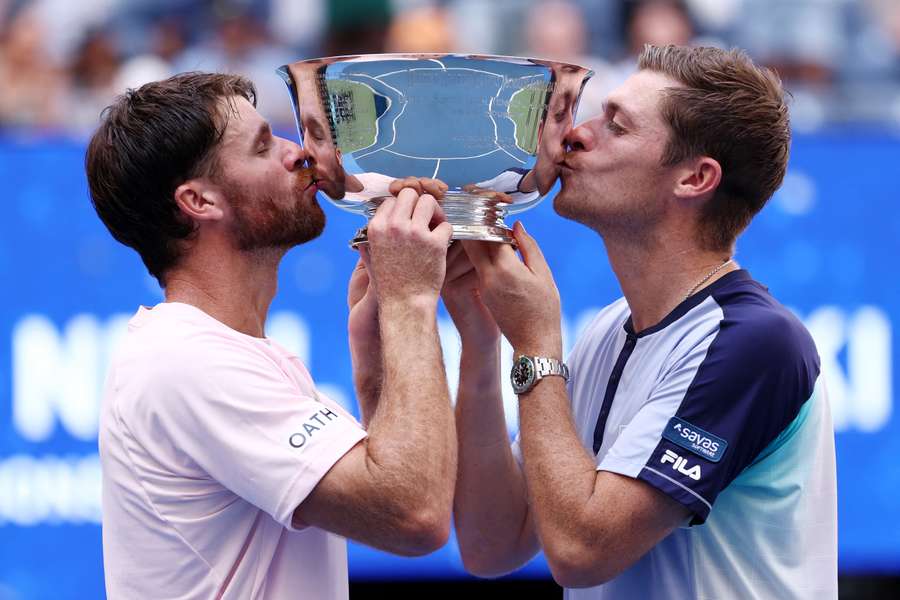 Christian Harrison and Neal Skupski kiss the trophy after defeating Kevin Krawietz and Tim Puetz in the men's doubles final