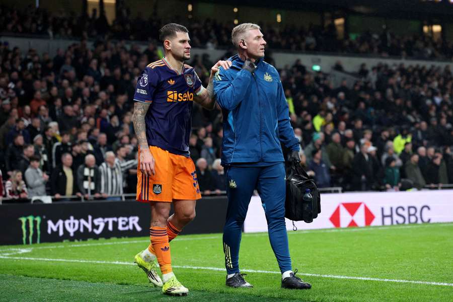 Bruno Guimaraes walks around the pitch after being substituted due to injury