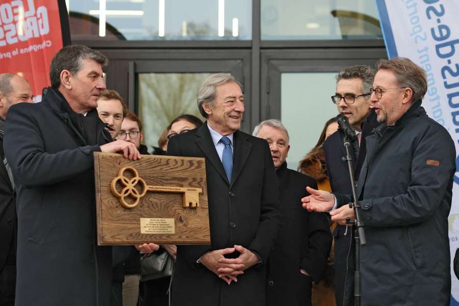 Georges Siffresi (C), president of the Haut-de-Seine district Council, receives the keys of the renovated and modernised Yves-du-Manoir stadium from Lionel Christolomme, chairman of the Leon Grosse board