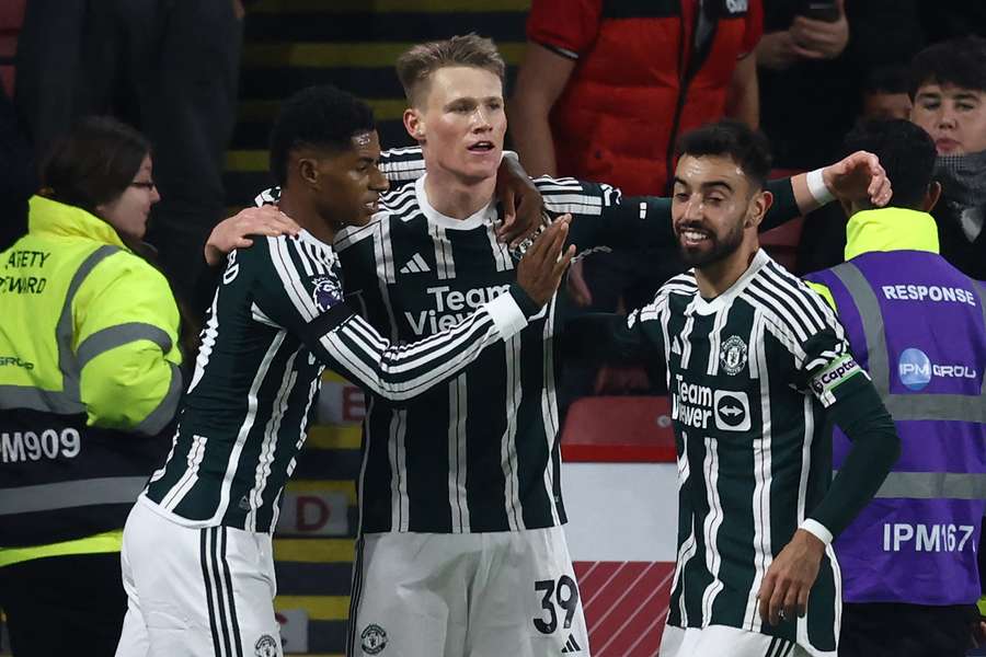 Manchester United's Scottish midfielder #39 Scott McTominay (C) celebrates with teammates after scoring the opening goal