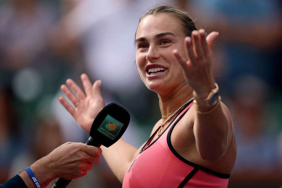 Aryna Sabalenka reacts to the crowd during an interview after her victory over Himeno Sakatsume