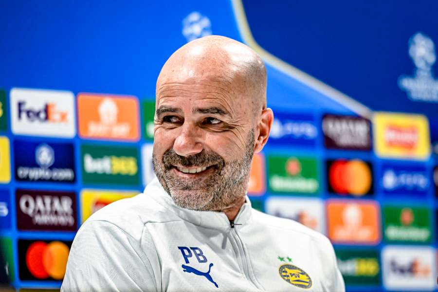 PSV manager Peter Bosz smiled during the pre-match press conference ahead of tomorrow's game against Arsenal