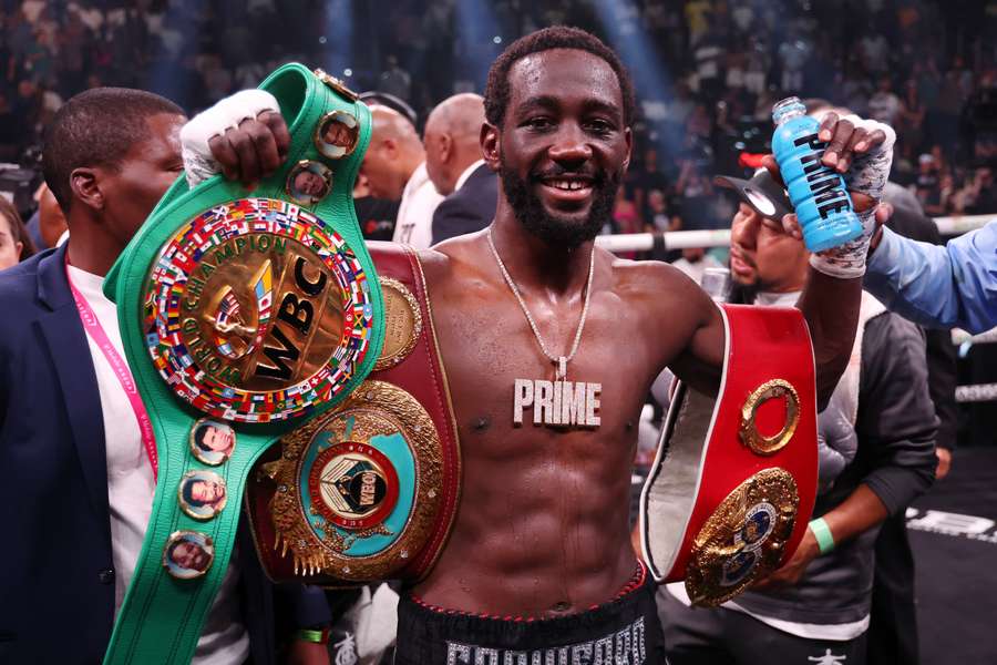 Terrence Crawford celebrates with his championship belts after defeating Errol Spence Jr.