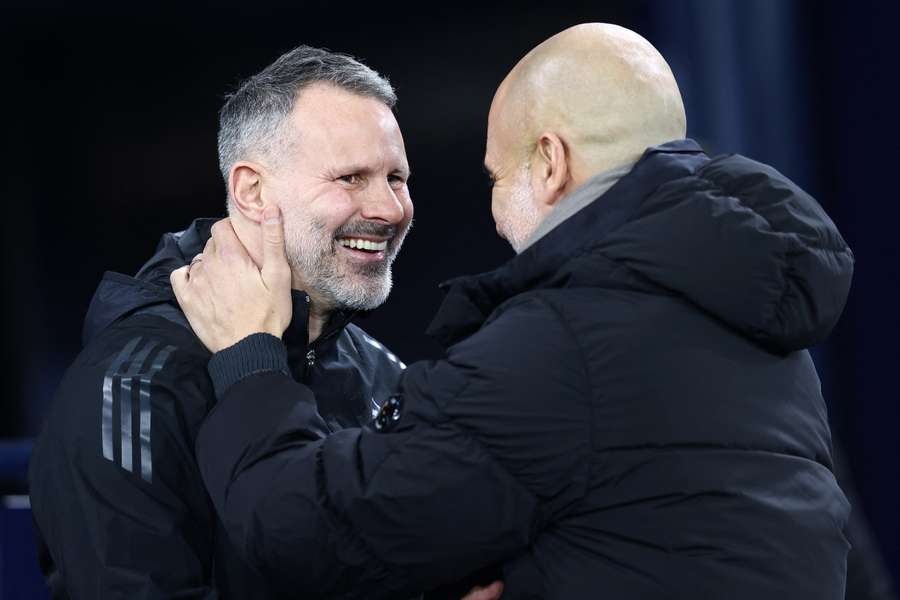 Giggs (L) is embraced by Pep Guardiola