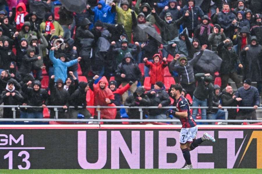 Orsolini celebrates at a rainy Bologna after scoring the winner 14 minutes from time