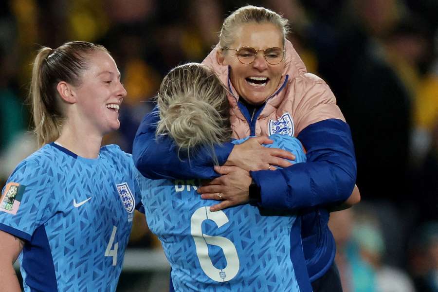 Millie Bright celebrates with coach Sarina Wiegman after the semi-final
