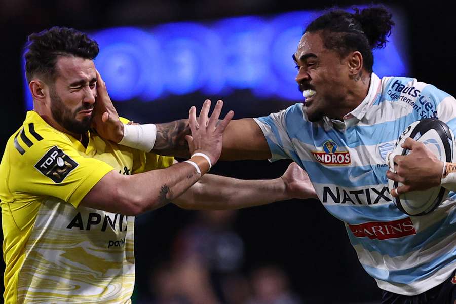 Racing92's New Zealand center Francis Saili is challenged by La Rochelle's French fly-half Antoine Hastoy 