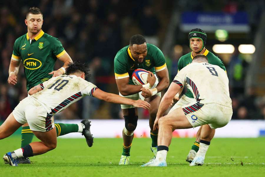 South Africa's Lukhanyo Am in action with England's Marcus Smith and Ben Earl