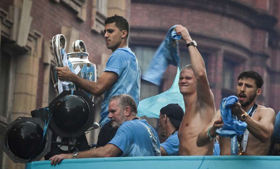 Rodri holds the Champions League trophy as he celebrates with teammates