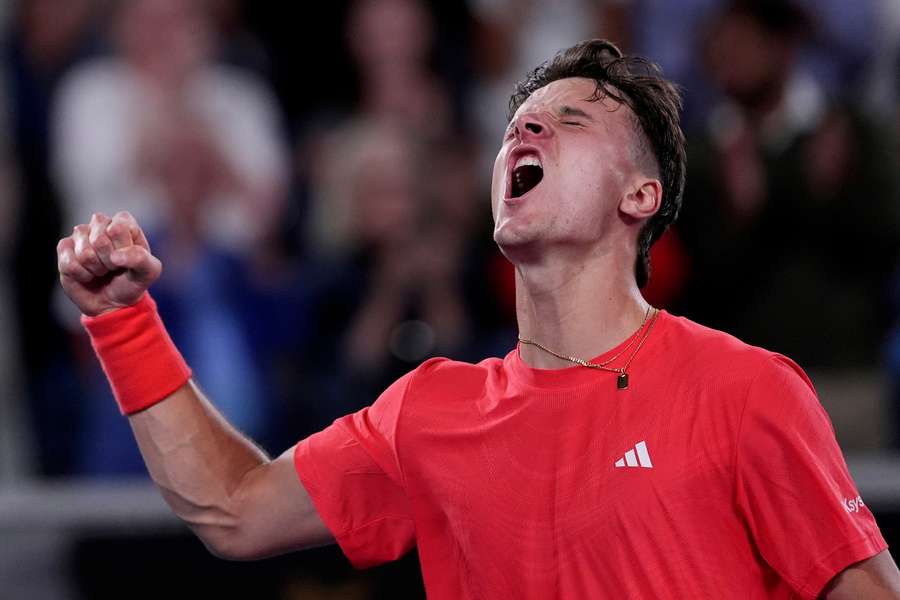 Mensik celebrates his win