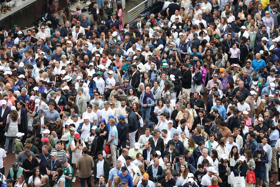 Spectators slowly pass through security checks prior to the men's US Open final on Sunday