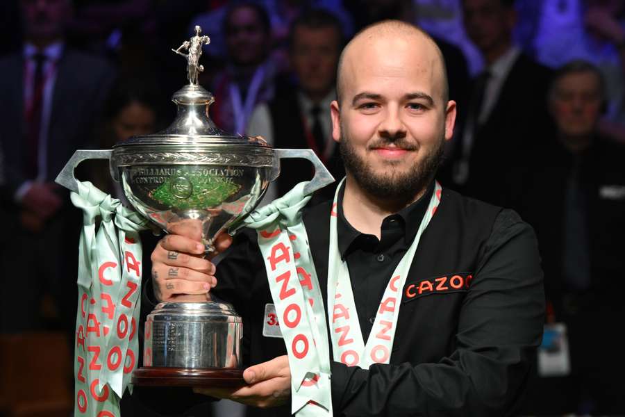 Belgium's Luca Brecel poses with the World Championship trophy after beating Mark Selby in the final