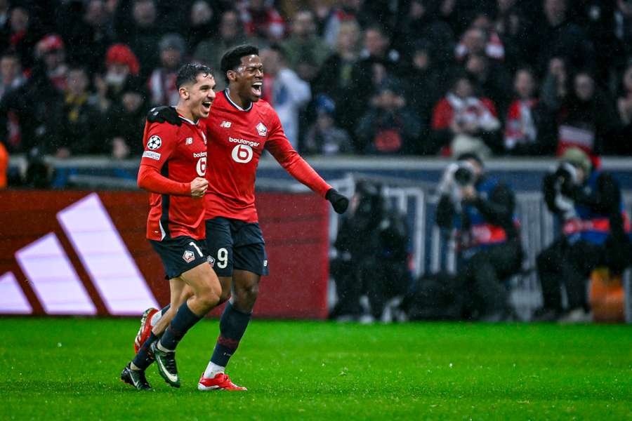 Osame Sahraoui and forward Jonathan David celebrate a goal 