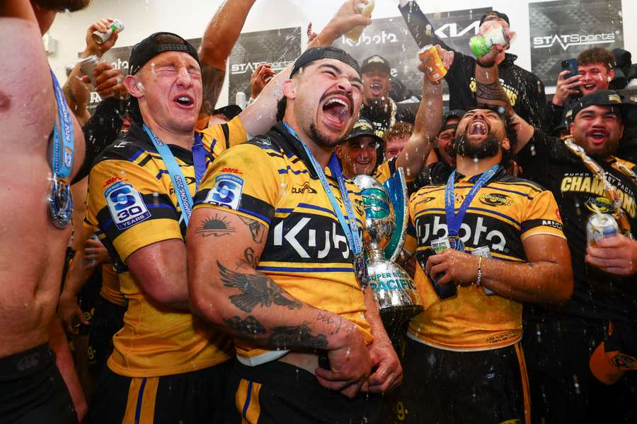 Hurricanes players celebrating their 2026 title win.