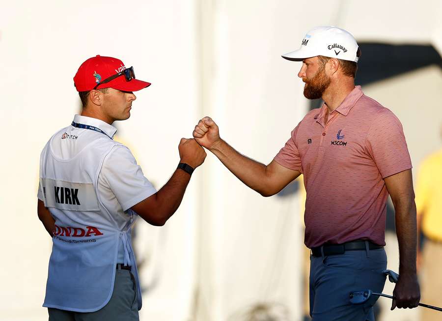 Chris Kirk of the United States fist bumps his caddie