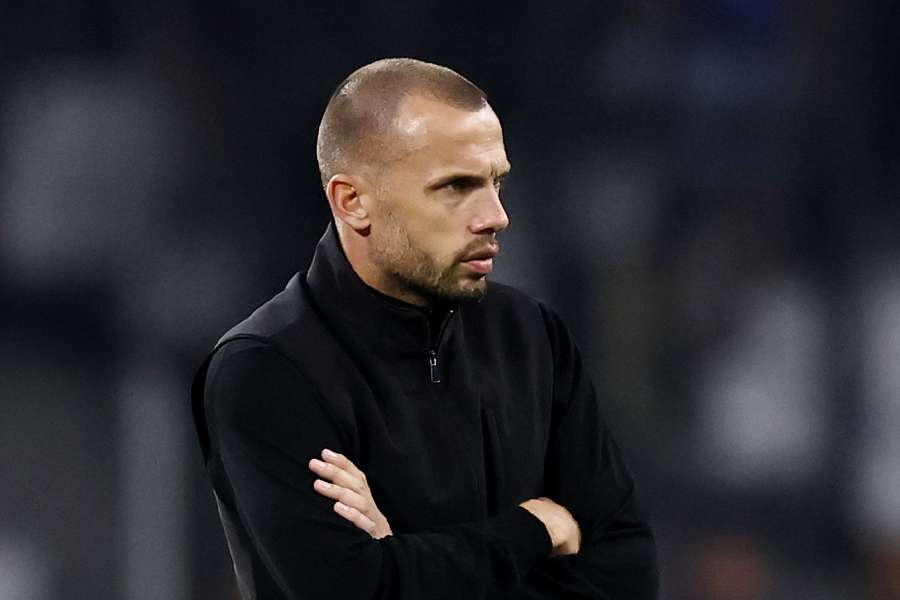 Ajax head coach Heitinga on the touchline