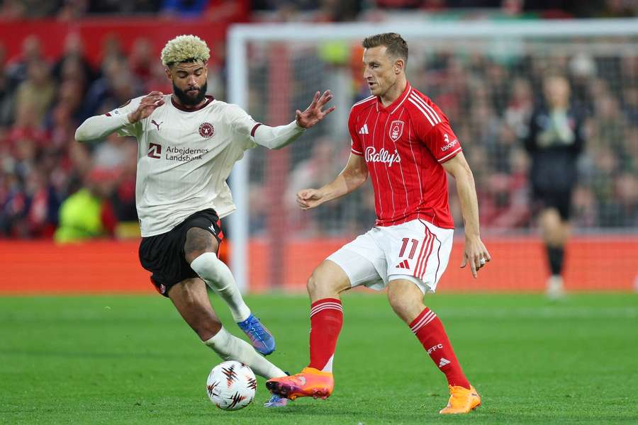 FC Midtjylland's Phillip Billing battles for the ball with Nottingham Forest's Chris Wood during the Europa League encounter